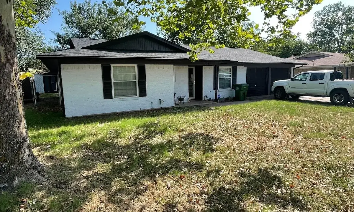Professional roofing crew working on a residential roof in Hope